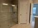 Modern bathroom featuring a glass-enclosed tiled shower and access door to the main bedroom at 8347 Ada St, Port Charlotte, FL 33981