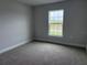Comfortable bedroom with plush carpeting, ample natural light from the window, and neutral paint at 8347 Ada St, Port Charlotte, FL 33981