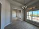 Dining room area with modern chandelier, tile floors and lots of natural light from the large windows at 8347 Ada St, Port Charlotte, FL 33981