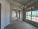 Inviting dining room features modern lighting and large windows, offering a serene and pleasant dining atmosphere at 8347 Ada St, Port Charlotte, FL 33981