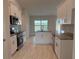 Modern kitchen features stainless steel appliances, granite countertops, and white cabinets at 8347 Ada St, Port Charlotte, FL 33981