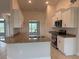 Bright, open kitchen featuring an island, white cabinets, granite counters, and stainless steel appliances at 8347 Ada St, Port Charlotte, FL 33981