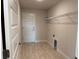 Functional laundry room with door to outside, tile flooring, and a wire rack for extra storage at 8347 Ada St, Port Charlotte, FL 33981