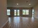 Open concept living room featuring tile floors, recessed lighting and glass doors leading to the outside at 8347 Ada St, Port Charlotte, FL 33981