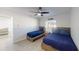 Bedroom with twin and full beds, ceiling fan, and view of living room at 176 N Waterway Nw Dr, Port Charlotte, FL 33952