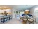 Bright dining area with a glass table and seating for six, adjacent to the kitchen at 25168 E Lenox Cir, Punta Gorda, FL 33950