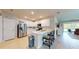Modern kitchen with white cabinets, stainless steel appliances, and breakfast bar at 25168 E Lenox Cir, Punta Gorda, FL 33950