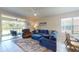 Relaxing living room featuring a sectional sofa, recliner, and sliding glass doors to patio at 25168 E Lenox Cir, Punta Gorda, FL 33950