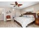 King-size bed in main bedroom with ceiling fan and access to bathroom at 754 Avenida Estancia # 160, Venice, FL 34292