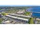 Aerial view of condo building near waterfront, featuring parking and surrounding landscape at 150 Harborside Ave # 216, Punta Gorda, FL 33950