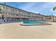 Inviting community pool area with plenty of lounge chairs at 150 Harborside Ave # 216, Punta Gorda, FL 33950
