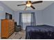 Bright bedroom with a ceiling fan, dresser, and comfortable seating at 150 Harborside Ave # 216, Punta Gorda, FL 33950