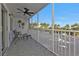 Screened balcony with seating and ceiling fan, overlooking parking lot at 150 Harborside Ave # 216, Punta Gorda, FL 33950