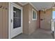 Condo entry with white door and screen, adjacent to building exterior at 150 Harborside Ave # 216, Punta Gorda, FL 33950