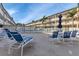 Relaxing community pool area with lounge chairs and tables at 150 Harborside Ave # 216, Punta Gorda, FL 33950