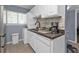 Condo kitchen with white cabinets, granite countertops, and dishwasher at 150 Harborside Ave # 216, Punta Gorda, FL 33950