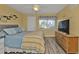 Main bedroom with comfortable bed, dresser, and large TV at 150 Harborside Ave # 216, Punta Gorda, FL 33950