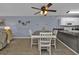 Bright dining area with table and chairs, hardwood floors, and access to kitchen at 150 Harborside Ave # 216, Punta Gorda, FL 33950