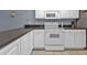Condo kitchen with white cabinets, granite counters, and stainless appliances at 150 Harborside Ave # 216, Punta Gorda, FL 33950