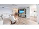Bright living room with hardwood floors, comfortable seating, and a large TV at 200 Harbor Walk Dr # 243, Punta Gorda, FL 33950