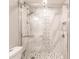 Walk-in shower with marble and geometric patterned tile at 200 Harbor Walk Dr # 243, Punta Gorda, FL 33950