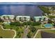 Aerial view of waterfront community with tennis courts and swimming pool at 200 Harbor Walk Dr # 243, Punta Gorda, FL 33950