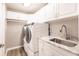 Bright laundry room with washer, dryer, and modern cabinetry at 200 Harbor Walk Dr # 243, Punta Gorda, FL 33950