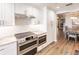 Modern kitchen with white cabinets, granite countertops, and stainless steel appliances at 200 Harbor Walk Dr # 243, Punta Gorda, FL 33950