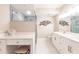Spa-like bathroom with double vanity, frameless shower, and decorative art at 200 Harbor Walk Dr # 243, Punta Gorda, FL 33950