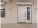 White front door with glass panels and storm door at 200 Harbor Walk Dr # 243, Punta Gorda, FL 33950