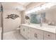 Bright bathroom with double vanity, frameless shower, and marble floors at 200 Harbor Walk Dr # 243, Punta Gorda, FL 33950
