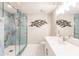 Modern bathroom with walk-in shower and marble tile at 200 Harbor Walk Dr # 243, Punta Gorda, FL 33950
