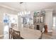 Elegant dining room with hardwood floors and a chandelier, overlooking the water at 200 Harbor Walk Dr # 243, Punta Gorda, FL 33950