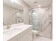 Elegant bathroom with a frameless shower, white vanity, and marble tile at 200 Harbor Walk Dr # 243, Punta Gorda, FL 33950