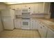 White kitchen with ample cabinetry and modern appliances at 255 Mission S Trl # J, Venice, FL 34285