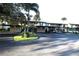 Exterior view of condo building with covered parking at 255 Mission S Trl # J, Venice, FL 34285