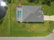 Overhead view of house showcasing roofline, pool, and driveway at 127 Rifle Rd, Rotonda West, FL 33947