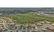 Aerial view of a residential neighborhood with lush landscaping, lakes, and well-maintained homes at 13064 Creekside Ln, Port Charlotte, FL 33953