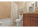Bathroom featuring a shower-tub combo with tile surround and wood vanity with granite countertop at 13064 Creekside Ln, Port Charlotte, FL 33953