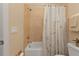 Bathroom featuring a tub-shower combo and neutral tile at 13064 Creekside Ln, Port Charlotte, FL 33953