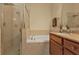 Bathroom featuring a separate shower, soaking tub, vanity with granite countertop, and tile surround at 13064 Creekside Ln, Port Charlotte, FL 33953