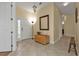 Inviting entryway featuring neutral tile floors, wood accents, and natural light at 13064 Creekside Ln, Port Charlotte, FL 33953