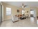 Bright living room with tile flooring, neutral walls, a ceiling fan, and large windows at 13064 Creekside Ln, Port Charlotte, FL 33953