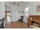 Cozy office space with desk, wood floors, and views of the pool through sliding glass door at 13064 Creekside Ln, Port Charlotte, FL 33953
