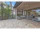 Cozy outdoor patio featuring a screened-in lanai with ceiling fan and comfortable seating area at 13064 Creekside Ln, Port Charlotte, FL 33953