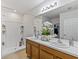 Main bathroom with double vanity, shower, and built-in shelves at 1817 W Price Blvd, North Port, FL 34286