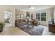 Bright living room with cozy seating and view into adjacent bedroom at 1817 W Price Blvd, North Port, FL 34286