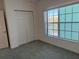 The bedroom has neutral carpet, a window with natural light, and a closet at 19375 Water Oak Dr # 302, Port Charlotte, FL 33948