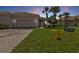 Single-story house with attached garage and well-maintained lawn at 13064 Creekside Ln, Port Charlotte, FL 33953