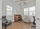 Home office with wood desk and comfortable seating at 13064 Creekside Ln, Port Charlotte, FL 33953